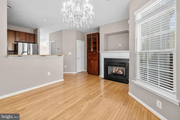 a view of a livingroom with a fireplace and window