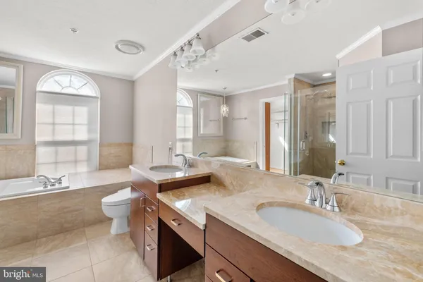 a spacious bathroom with a double vanity sink mirror and double