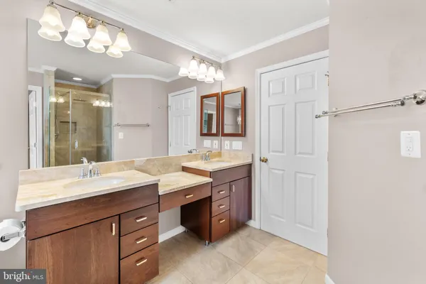 a spacious bathroom with a granite countertop sink toilet mirror and bathtub