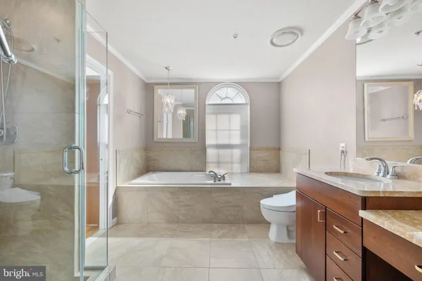 a spacious bathroom with a bathtub shower and mirror