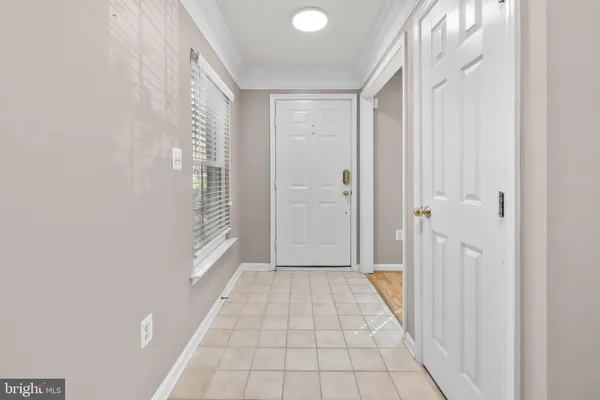 a view of a room with wooden floor and a window