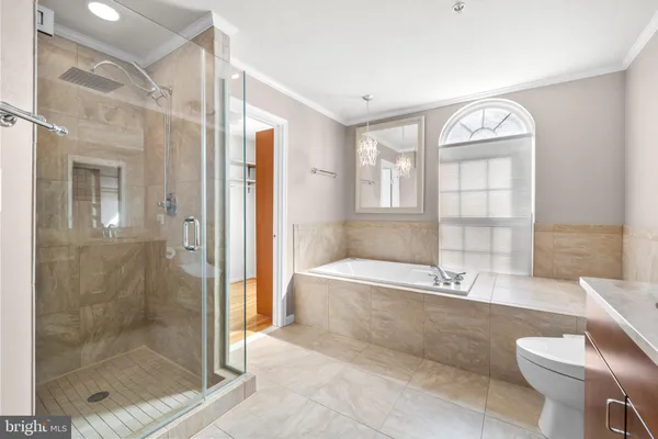a bathroom with a shower and a glass door