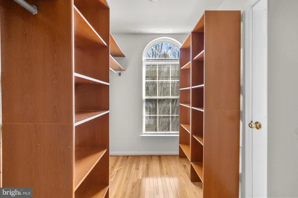 a view of walk in closet with empty racks