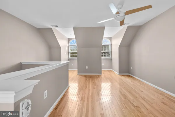 a view of an empty room and wooden floor