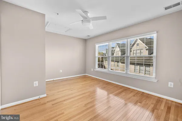 a view of an empty room with wooden floor
