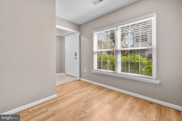 a view of an entryway with wooden floor and door
