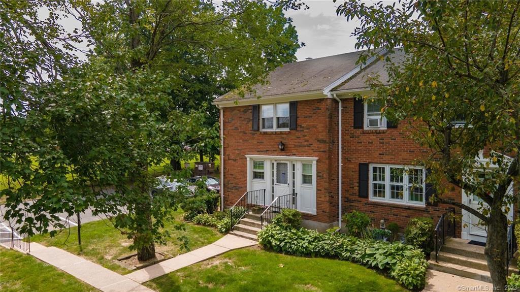 1 Brandywine Lane, Unit 1 Suffield, CT 06078 - Photo 1 of 1 front view of a house with a yard