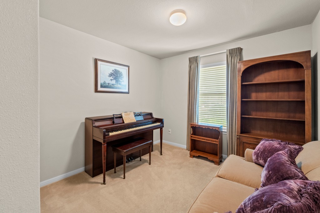 12008 Lansdowne Road Austin, TX 78754 - Photo 21 of 29 Warm carpeting and natural light define this inviting study, perfect for quiet contemplation or musical endeavors.