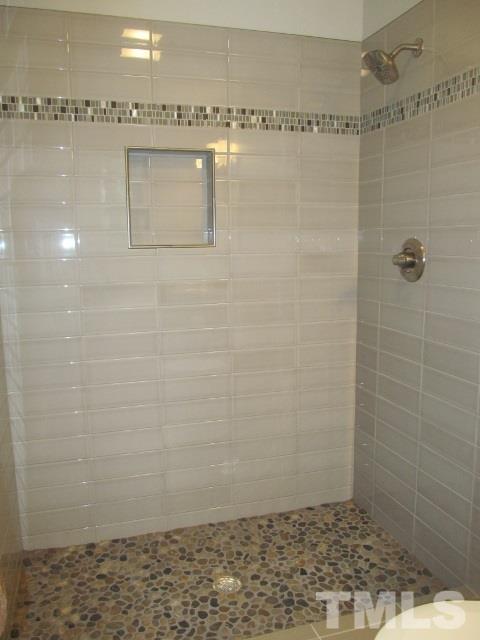 4003 Hope Valley Road Durham, NC 27707 - Photo 16 of 20 Master bath has new subway tile and pebbled floor in large walk in shower.