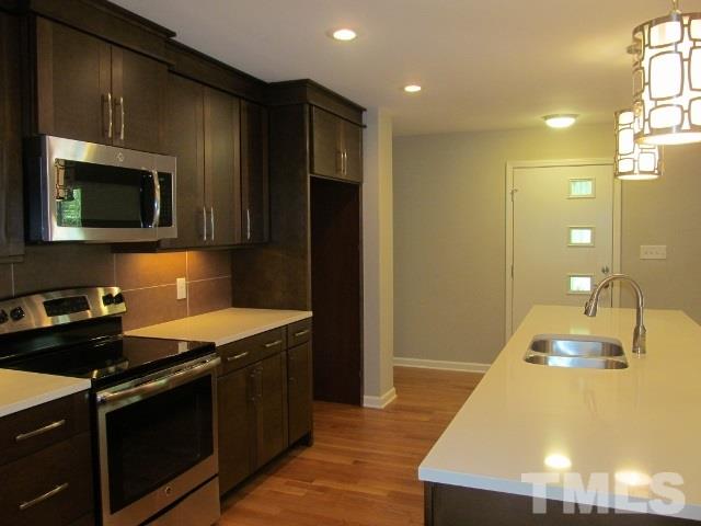 4003 Hope Valley Road Durham, NC 27707 - Photo 7 of 20 New natural oak flooring add a great contrast to the rich color of the cabinets.