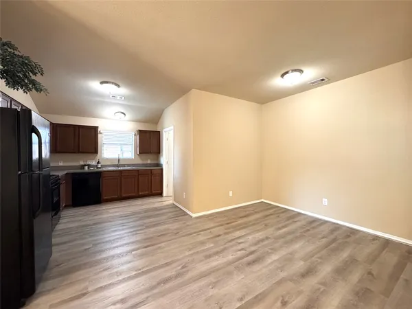 a view of kitchen with cabinets and stainless steel appliances