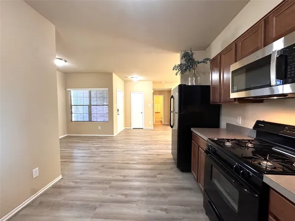 a kitchen with stainless steel appliances a refrigerator stove and microwave