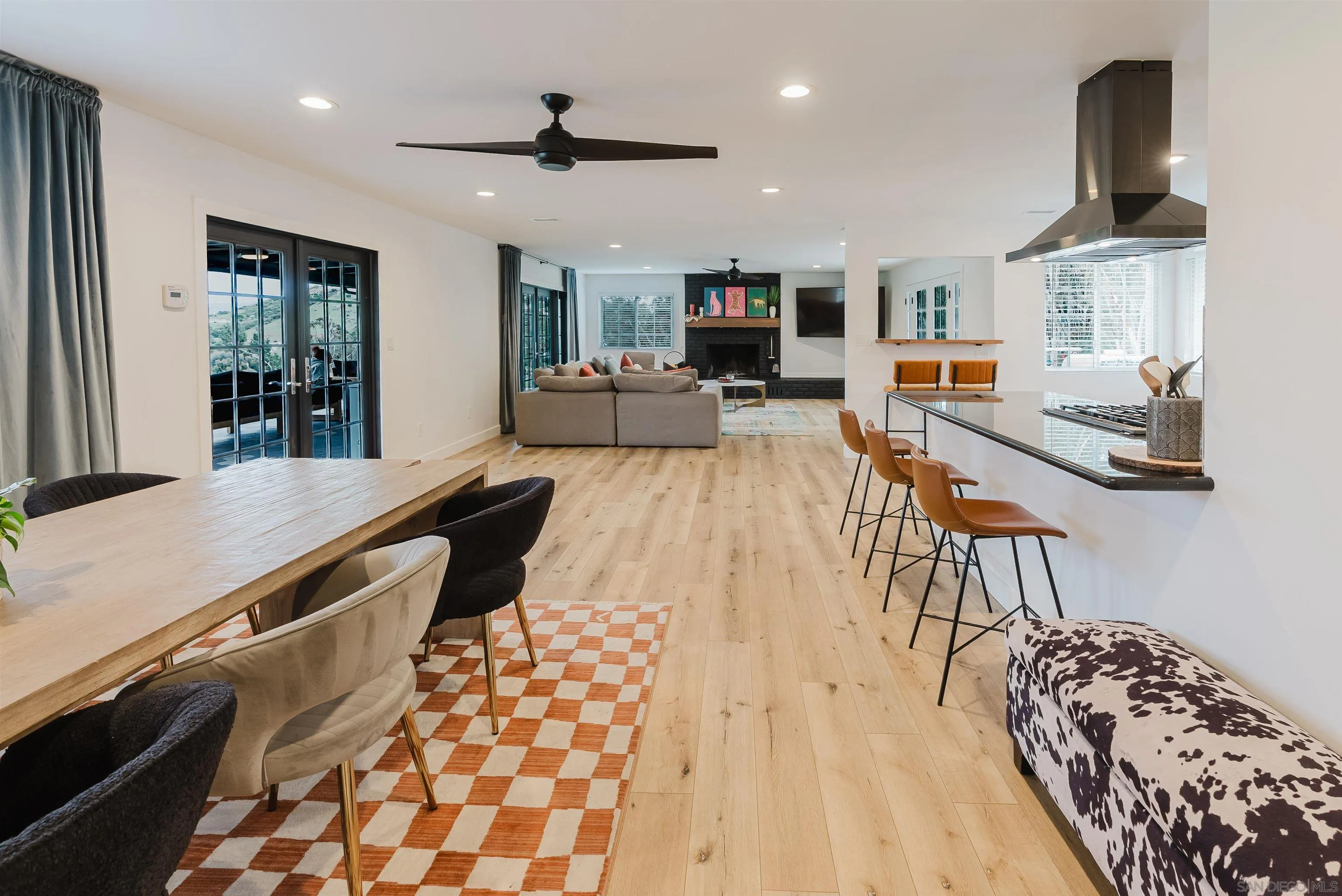 11911 Rocoso Road Lakeside, CA 92040 - Photo 11 of 32 a living room with stainless steel appliances kitchen island granite countertop furniture a rug and a view of kitchen