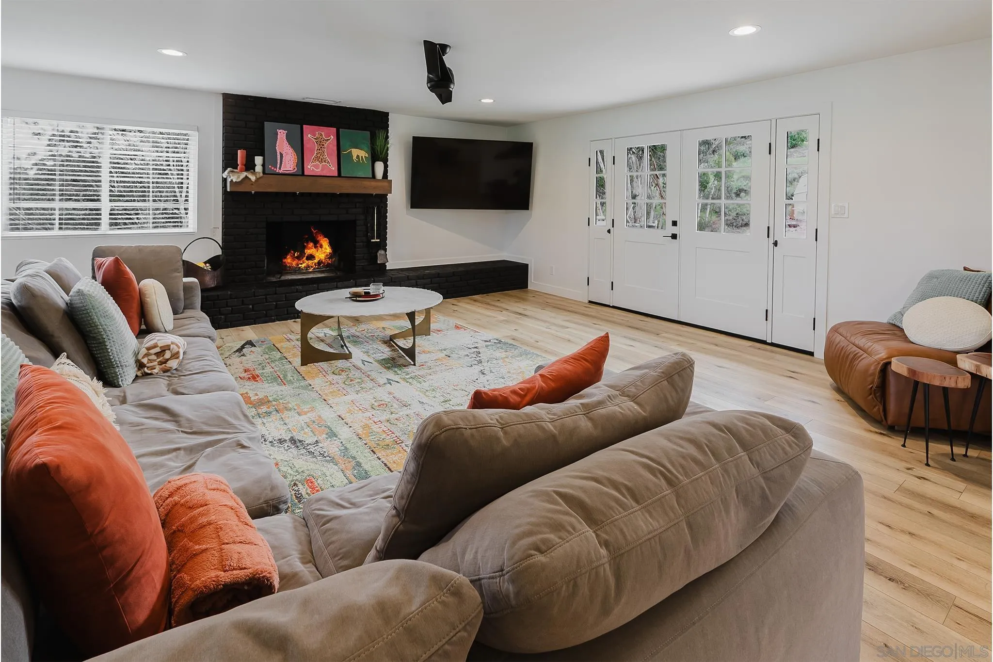 11911 Rocoso Road Lakeside, CA 92040 - Photo 12 of 32 a living room with furniture a flat screen tv and a fireplace