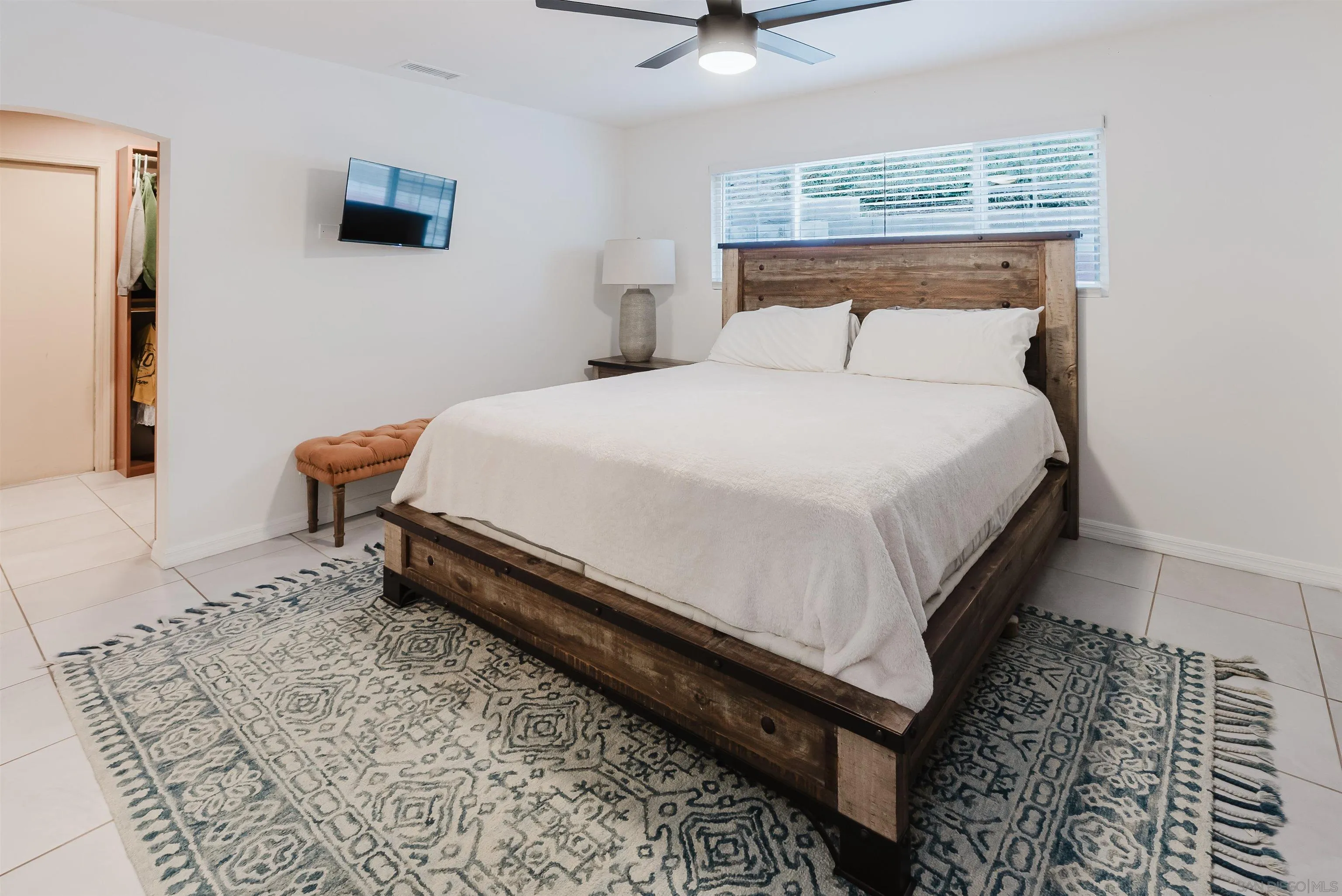 11911 Rocoso Road Lakeside, CA 92040 - Photo 17 of 32 a large bed sitting in a bedroom next to a window