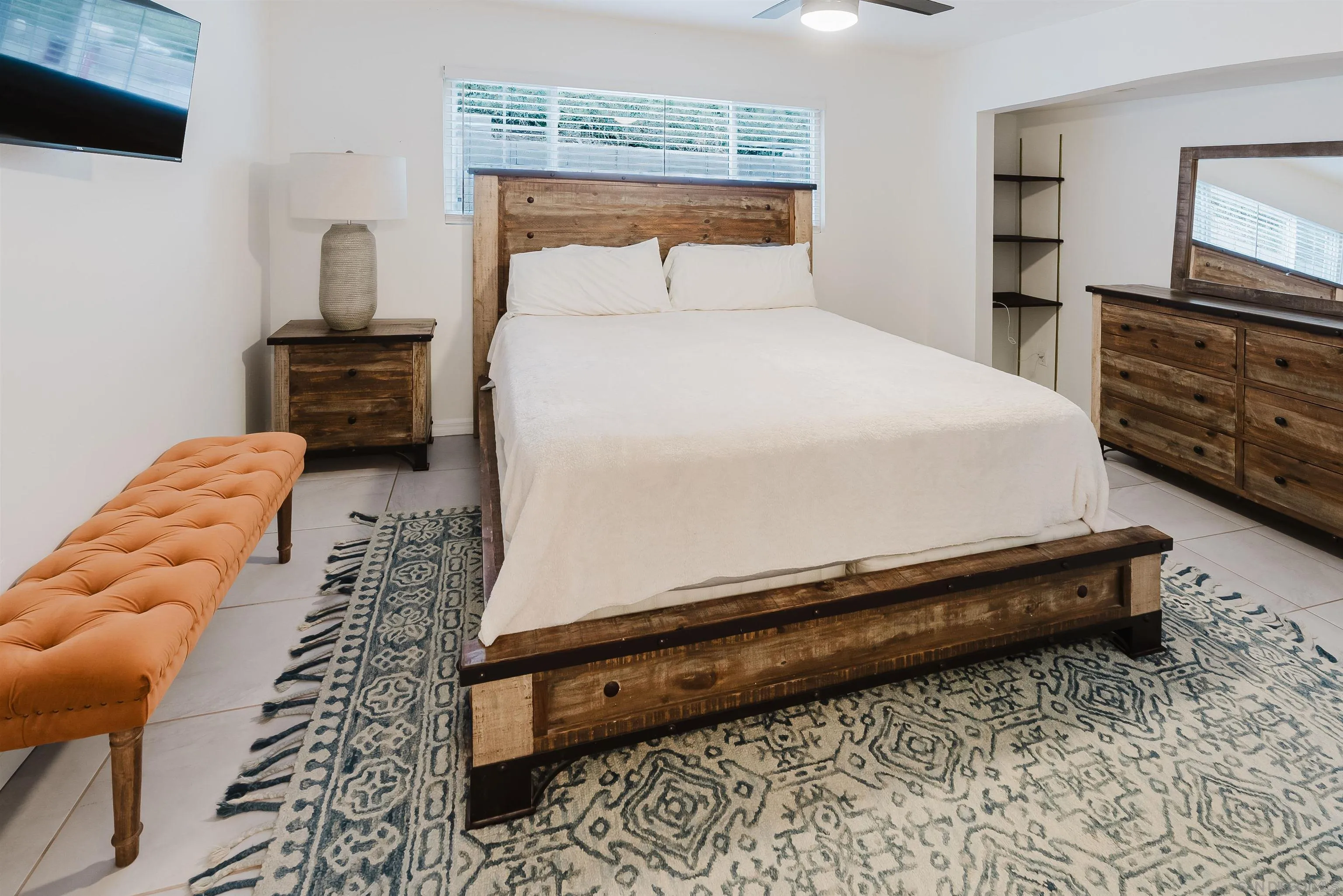 11911 Rocoso Road Lakeside, CA 92040 - Photo 18 of 32 a bedroom with a bed and a television