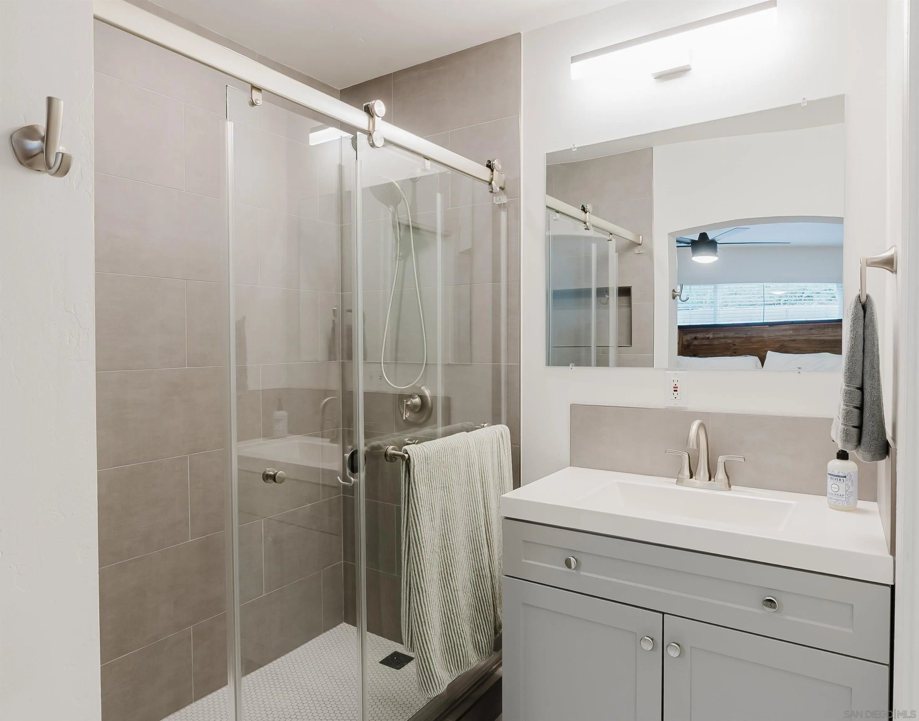 11911 Rocoso Road Lakeside, CA 92040 - Photo 20 of 32 a bathroom with a shower sink and mirror