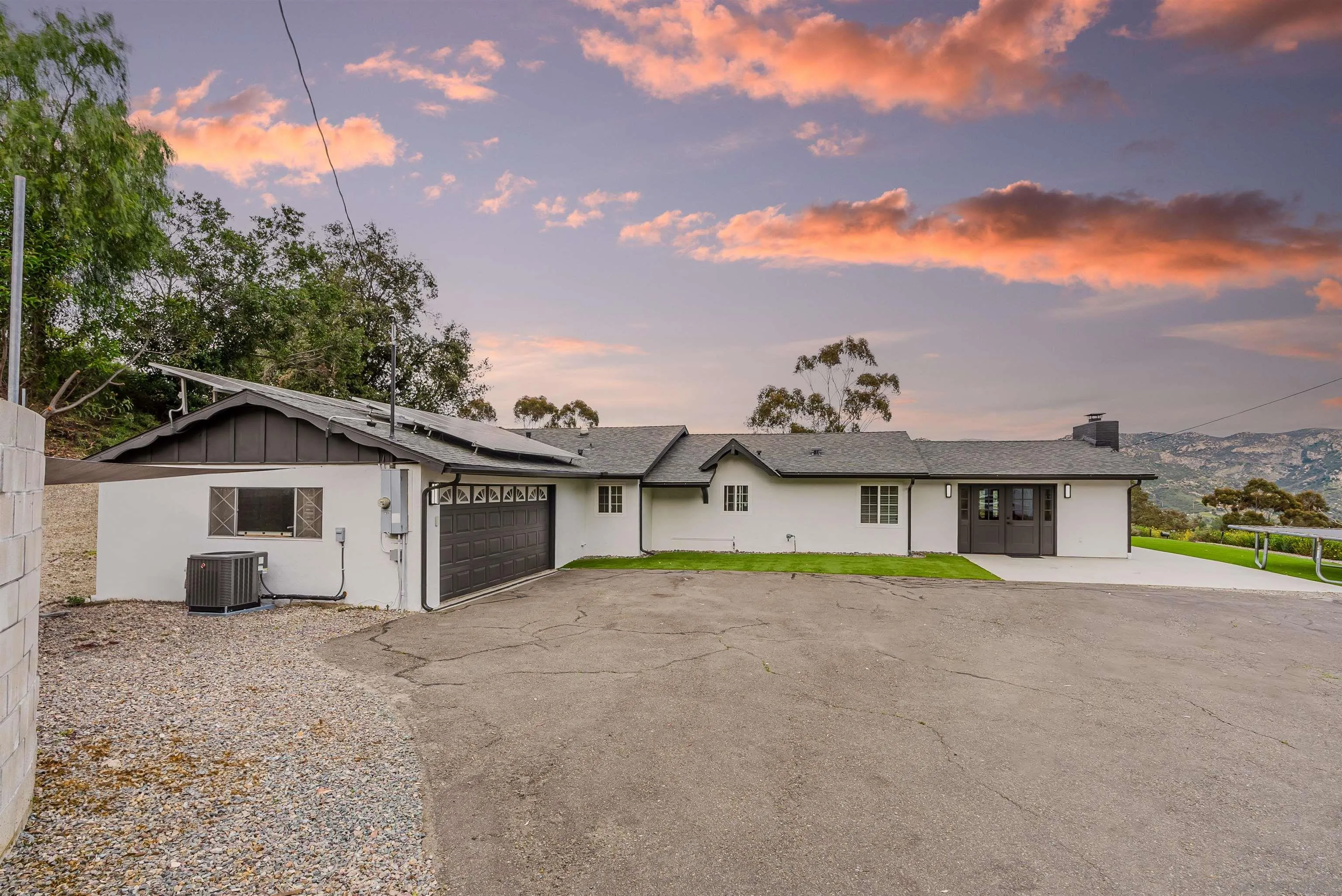 11911 Rocoso Road Lakeside, CA 92040 - Photo 7 of 32 a view of a house with a big yard and large trees