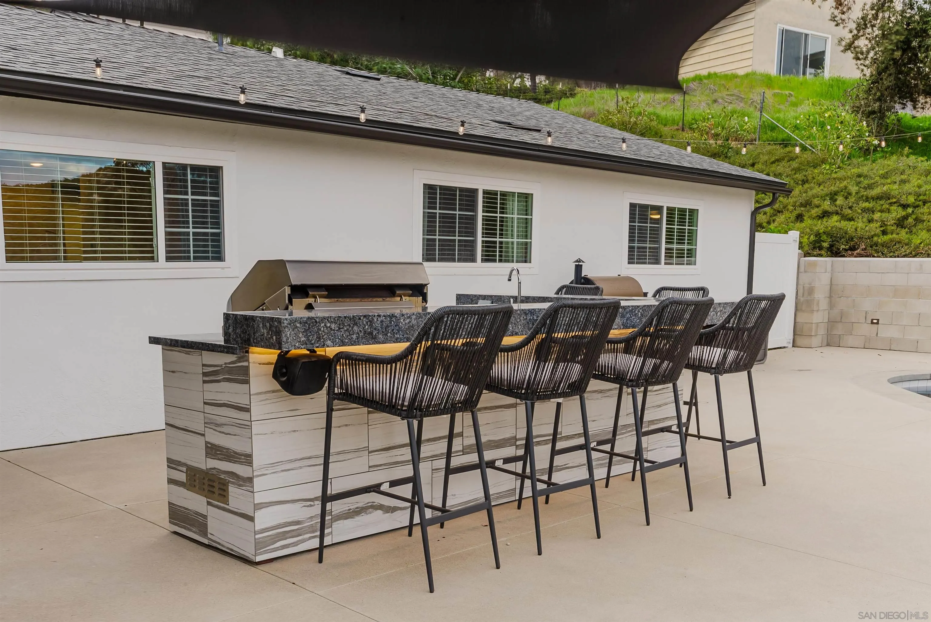 11911 Rocoso Road Lakeside, CA 92040 - Photo 8 of 32 a view of a patio with table and chairs with wooden floor and plants