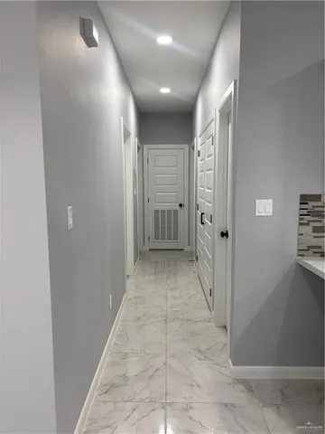 a view of an empty room with a ceiling fan