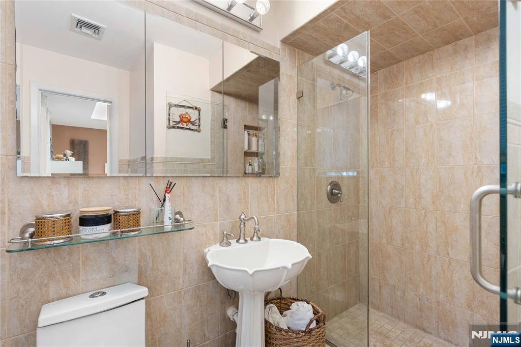 1675 Broad Street Bloomfield, NJ 07003 - Photo 12 of 35 a bathroom with a sink a toilet and shower