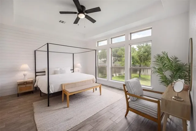 a spacious bedroom with a bed a couch and a window