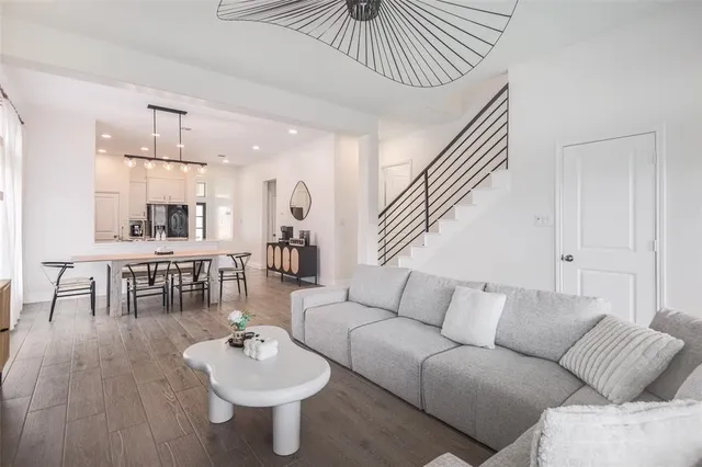 a living room with furniture and kitchen view