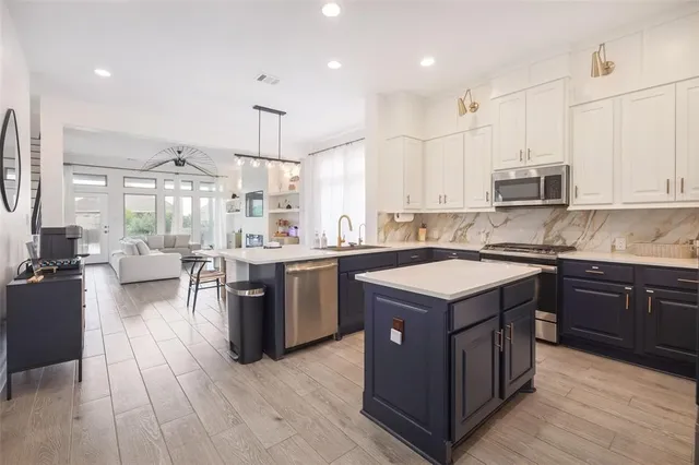 a kitchen with a stove sink and cabinets