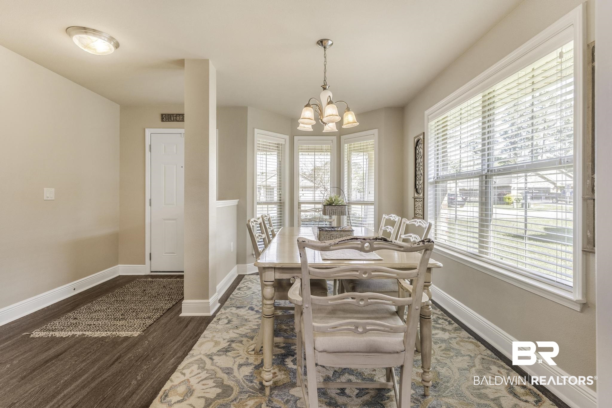 22043 Garland Loop Silverhill, AL 36576 - Photo 8 of 41 Dining room featuring suspended lighting and dark wood-style floors