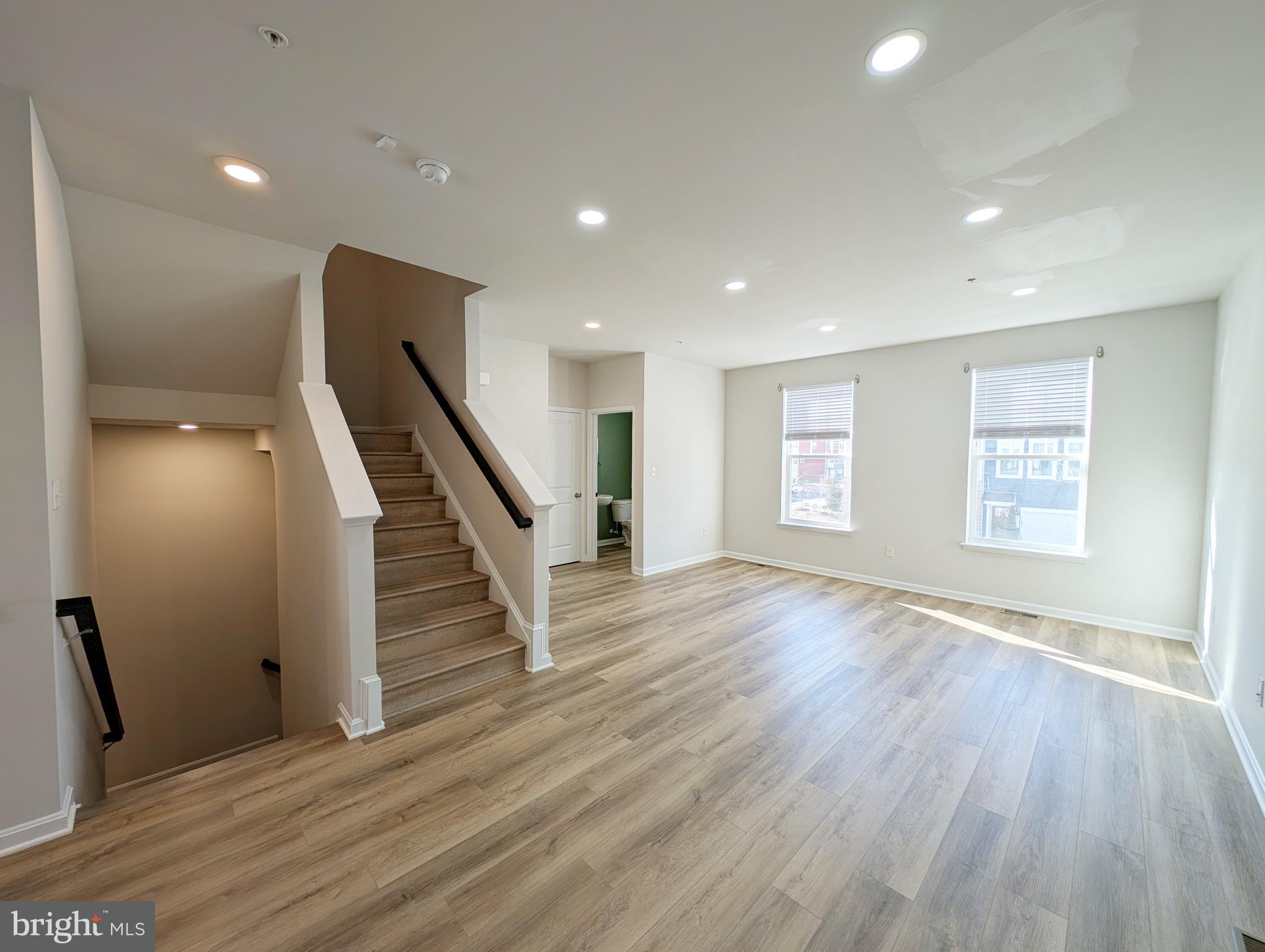 3106 Laurel Hill Road Hanover, MD 21076 - Photo 11 of 27 an empty room with wooden floor and staircase
