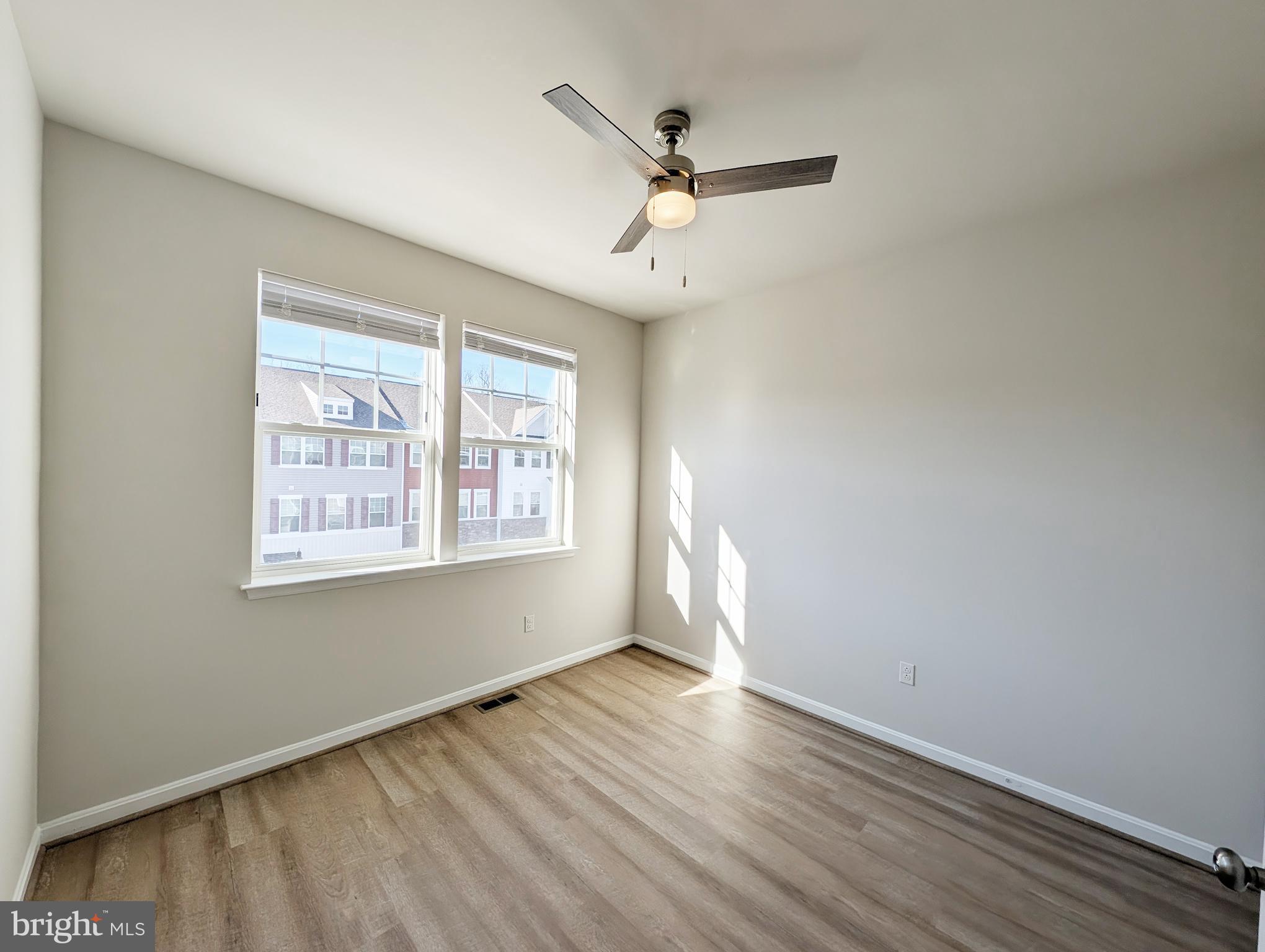 3106 Laurel Hill Road Hanover, MD 21076 - Photo 15 of 27 a view of empty room with wooden floor and fan