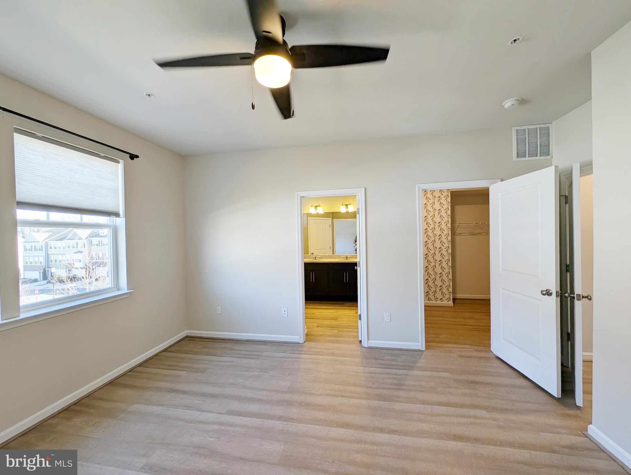 3106 Laurel Hill Road Hanover, MD 21076 - Photo 19 of 27 a view of an empty room with wooden floor and a window