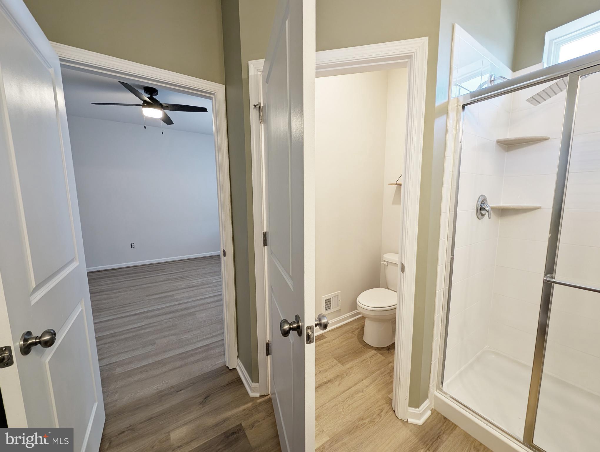3106 Laurel Hill Road Hanover, MD 21076 - Photo 20 of 27 a bathroom with a granite countertop shower a toilet and a sink