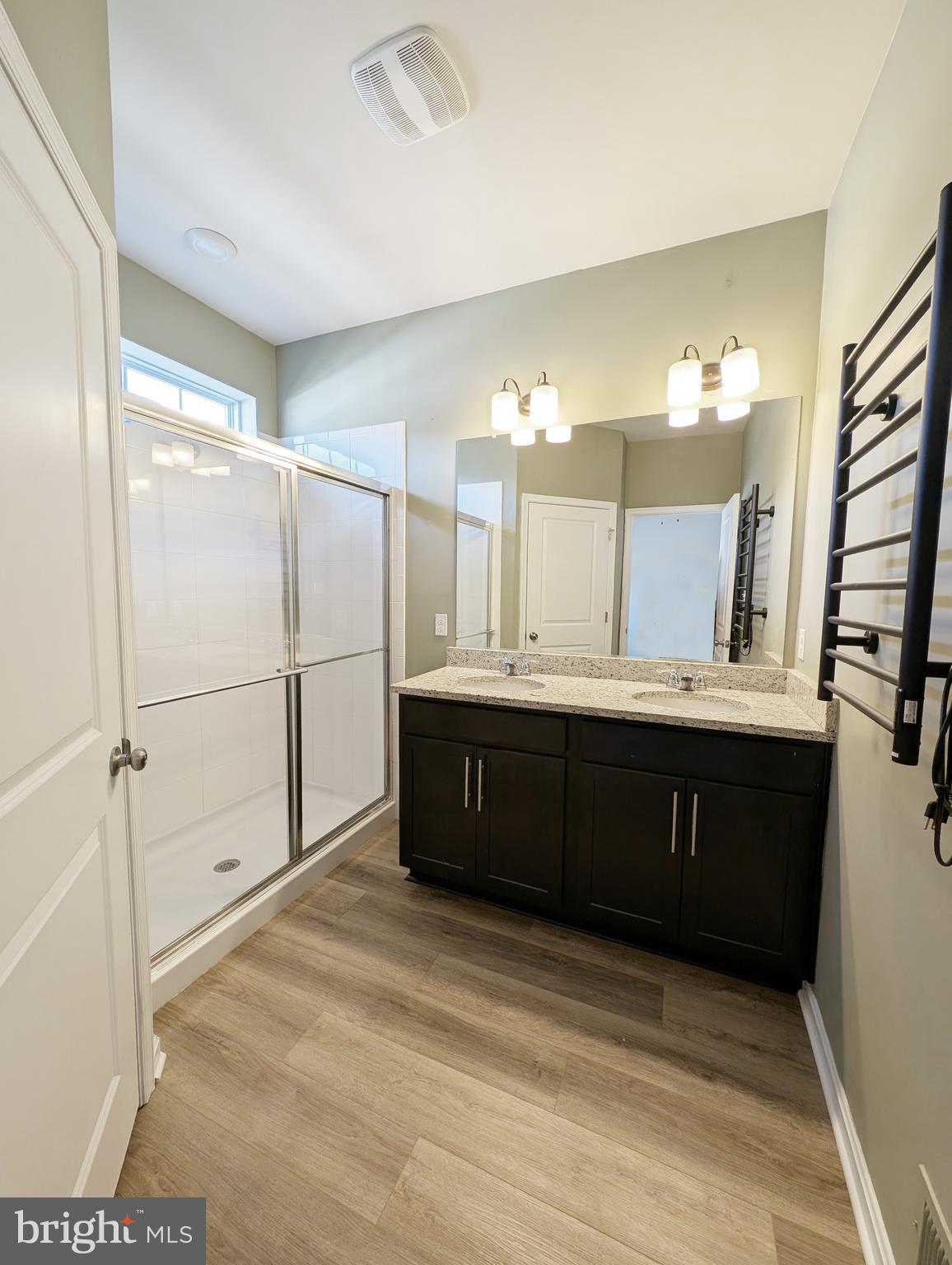 3106 Laurel Hill Road Hanover, MD 21076 - Photo 21 of 27 a bathroom with a double vanity sink a mirror and shower