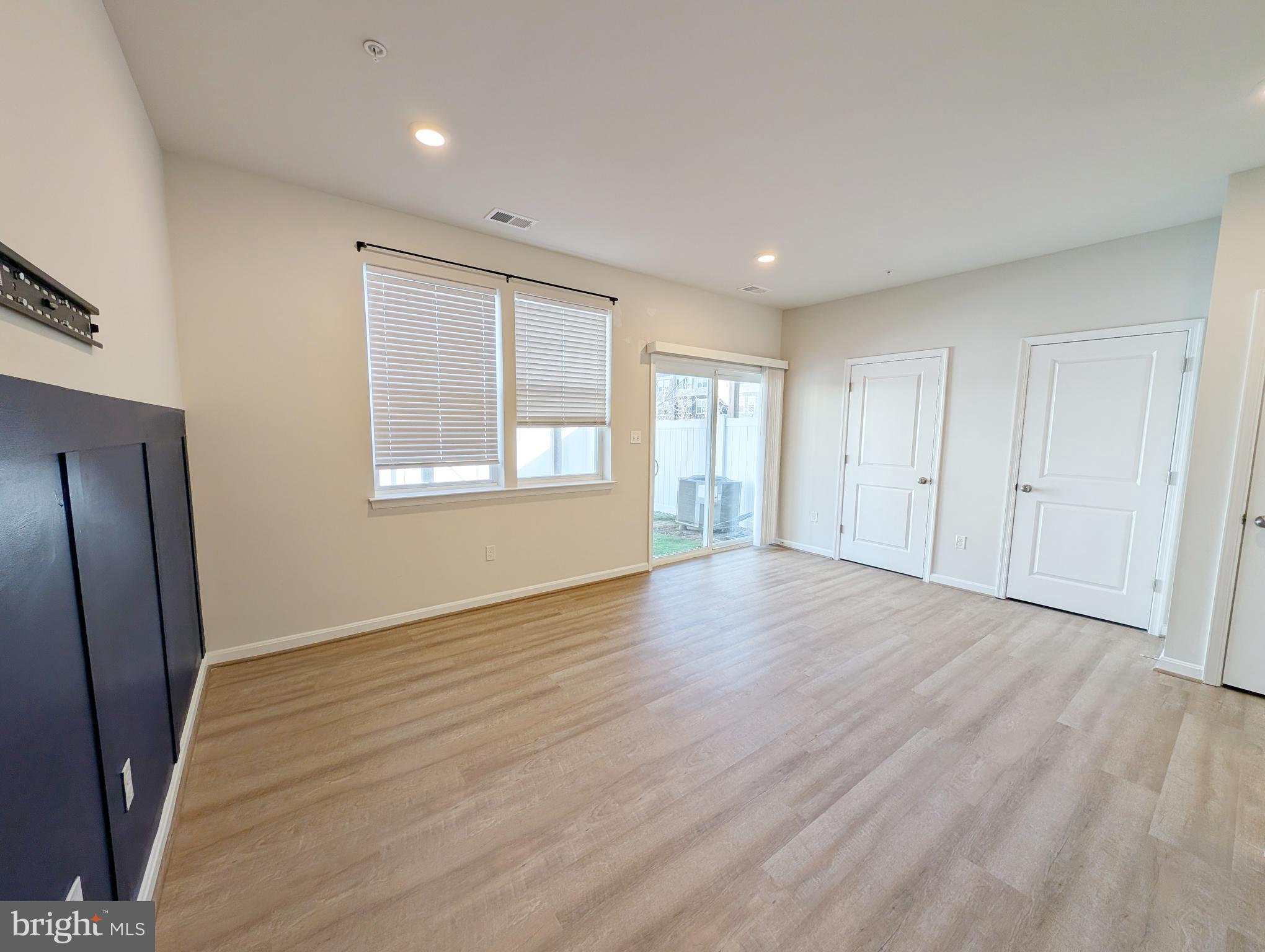 3106 Laurel Hill Road Hanover, MD 21076 - Photo 24 of 27 an empty room with wooden floor and windows
