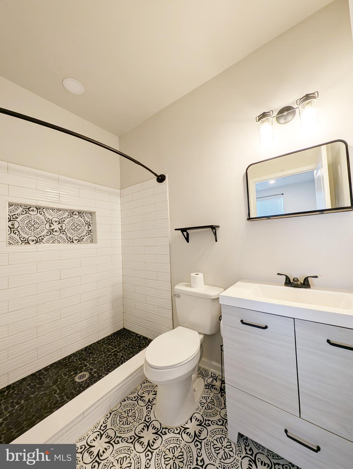 3106 Laurel Hill Road Hanover, MD 21076 - Photo 25 of 27 a bathroom with a toilet a sink and mirror