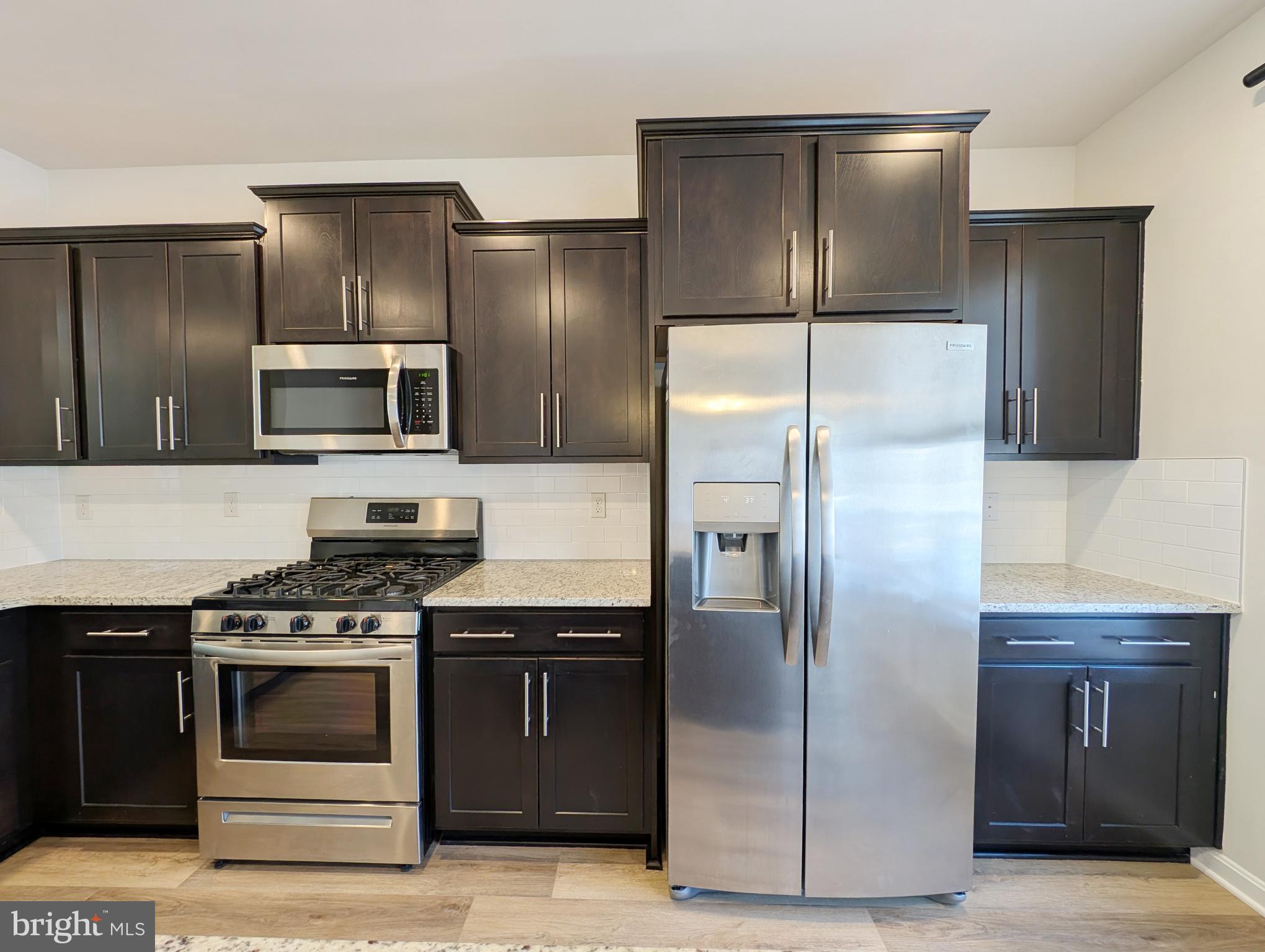 3106 Laurel Hill Road Hanover, MD 21076 - Photo 8 of 27 a kitchen with stainless steel appliances granite countertop a refrigerator and a stove