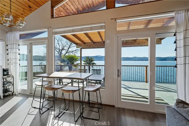 a kitchen with a table chairs refrigerator and cabinets