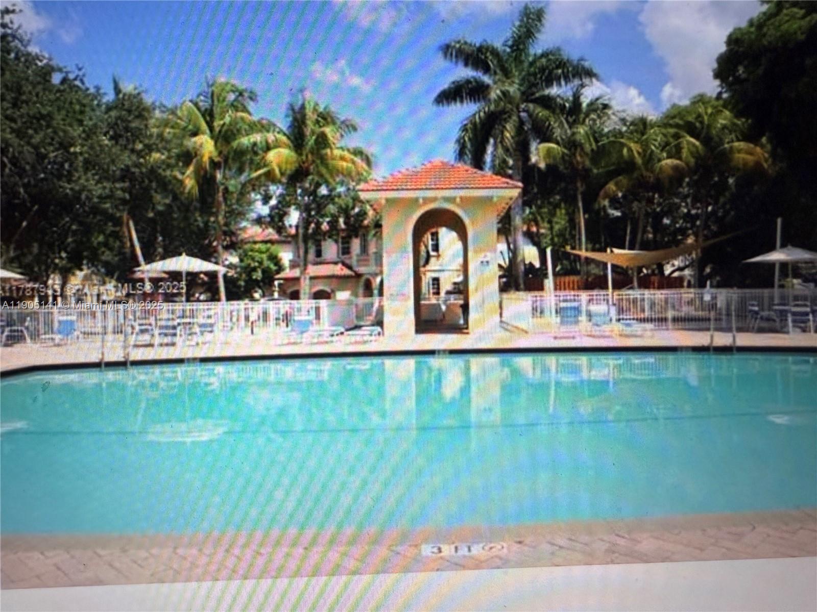 4932 Southwest 140th Terrace, Unit 1 Miramar, FL 33027 - Photo 23 of 27 a view of a house with a swimming pool