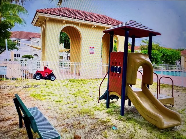 a front view of a house with a garden and a garage