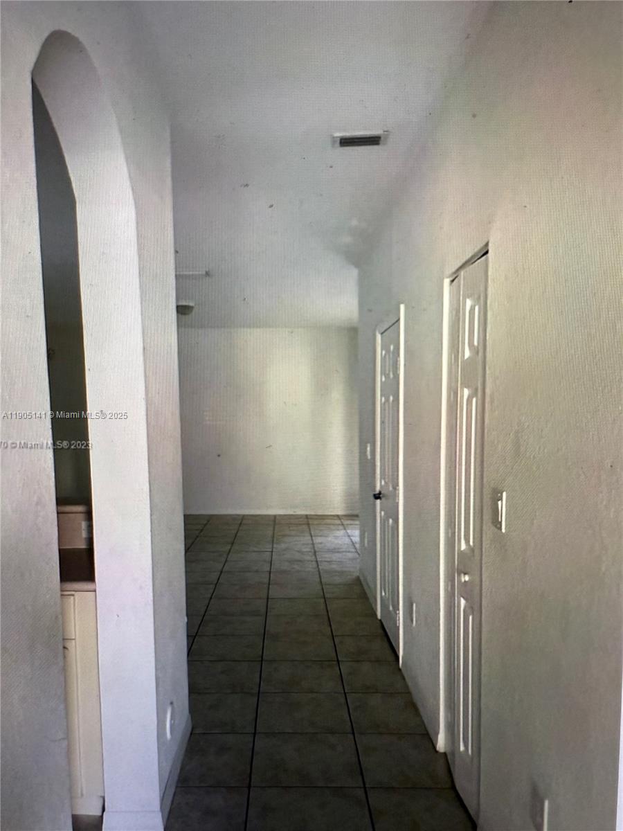 4932 Southwest 140th Terrace, Unit 1 Miramar, FL 33027 - Photo 4 of 27 a view of hallway with a large mirror