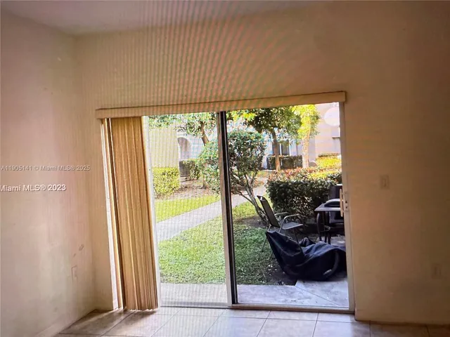 a view of a porch and floor to ceiling window