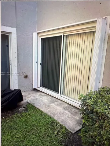 a view of a kitchen with a sink and a window