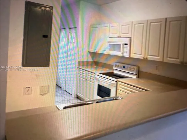 a kitchen with a stove top oven and cabinets