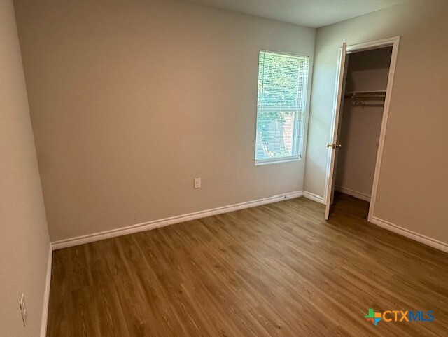 2410 Westcliff Road, Unit A & B Killeen, TX 76543 - Photo 13 of 21 an empty room with wooden floor and windows