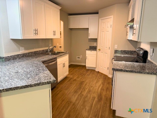 2410 Westcliff Road, Unit A & B Killeen, TX 76543 - Photo 5 of 21 a kitchen with granite countertop wooden floors and white stainless steel appliances