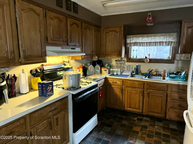 a living room with furniture a rug a fireplace and a window