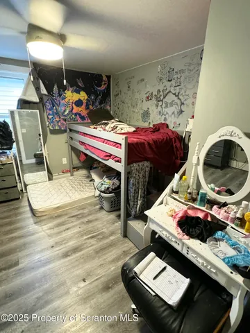 a view of a living room with wooden floor