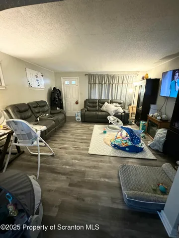 a view of living room filled with furniture and a couch