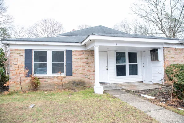 a front view of a house with a yard and glass windows